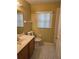 Cozy bathroom with black and white tiled floors and vanity at 1797 Tillstream Dr, Orlando, FL 32818