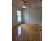 Bright bedroom with hardwood floors, a ceiling fan, and a spacious closet at 1797 Tillstream Dr, Orlando, FL 32818