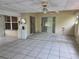 Spacious Florida room with tile flooring, ceiling fan, sliding doors leading to the backyard, and utility connections at 1797 Tillstream Dr, Orlando, FL 32818