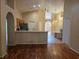 Open-concept layout connecting the kitchen and living room with hardwood floors and natural light at 1797 Tillstream Dr, Orlando, FL 32818