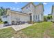 Backyard view featuring a grill and dining set on a concrete patio with a well-maintained lawn at 183 Longview Ave, Kissimmee, FL 34747