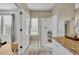 Modern bathroom features a glass-enclosed shower, granite counters, and a neutral color palette at 183 Longview Ave, Kissimmee, FL 34747