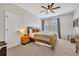 Comfortable bedroom with soft carpet, ceiling fan, and a cozy bed with stylish furnishings at 183 Longview Ave, Kissimmee, FL 34747