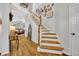 Bright foyer features hardwood floors, staircase, and artwork, leading to the living spaces at 183 Longview Ave, Kissimmee, FL 34747