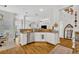 Kitchen with stainless appliances, breakfast bar, and open layout to living and dining spaces at 183 Longview Ave, Kissimmee, FL 34747