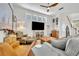 Cozy living room boasts a modern ceiling fan, stylish decor, and stairway access at 183 Longview Ave, Kissimmee, FL 34747