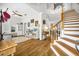 Spacious living area featuring wood floors, natural light, and an open staircase at 183 Longview Ave, Kissimmee, FL 34747