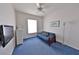 Guest bedroom featuring a futon, blue carpet, and a TV at 204 Quail Trail Ct, Lake Mary, FL 32746