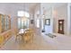 Elegant dining room with chandelier, large windows, and views of front exterior at 204 Quail Trail Ct, Lake Mary, FL 32746