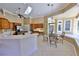 Spacious kitchen with island cooktop, breakfast nook, and pool views at 204 Quail Trail Ct, Lake Mary, FL 32746