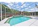 This screened in pool features turquoise water and a beautiful outdoor setting at 204 Quail Trail Ct, Lake Mary, FL 32746