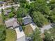 Aerial view of home featuring a new roof, screened porch, and concrete driveway amid lush landscaping at 235 Ruth Blvd, Longwood, FL 32750