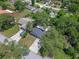 Aerial view of home featuring a new roof, screened porch, and concrete driveway amid lush landscaping at 235 Ruth Blvd, Longwood, FL 32750