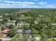 Aerial view of property in a tranquil, wooded neighborhood, with a nearby pond and open skies at 235 Ruth Blvd, Longwood, FL 32750