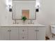 This bathroom features a double vanity with modern fixtures and a large mirror at 235 Ruth Blvd, Longwood, FL 32750