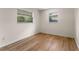 Bedroom featuring wood floors, neutral walls, and two windows for natural light at 235 Ruth Blvd, Longwood, FL 32750