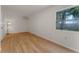 Bedroom with light wood floors, bright window, and a wall-mounted AC unit at 235 Ruth Blvd, Longwood, FL 32750
