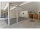 View of the covered parking area, featuring a detached garage, a well-maintained concrete floor and a fenced yard at 235 Ruth Blvd, Longwood, FL 32750
