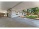 View of the covered parking area, featuring a detached garage, a well-maintained concrete floor and a fenced yard at 235 Ruth Blvd, Longwood, FL 32750