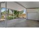 View of the covered parking area, featuring a detached garage, a well-maintained concrete floor and a fenced yard at 235 Ruth Blvd, Longwood, FL 32750