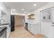 Modern kitchen features white cabinetry, marble countertops, stainless steel appliances, and wood-style flooring at 235 Ruth Blvd, Longwood, FL 32750