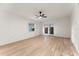 Bright living room features light wood floors, fan, and access to a patio at 235 Ruth Blvd, Longwood, FL 32750