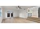 Open living room with access to kitchen and an outdoor patio with wood-look flooring at 235 Ruth Blvd, Longwood, FL 32750