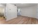 Spacious living area showcases light wood floors and access to a bathroom and kitchen area at 235 Ruth Blvd, Longwood, FL 32750