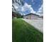 Exterior showing a new paver driveway, green lawn, and backyard of this charming home at 2420 Graham Dr, Orlando, FL 32807