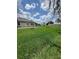 Expansive backyard with lush green lawn and rear home exterior, perfect for outdoor activities and entertaining at 2420 Graham Dr, Orlando, FL 32807
