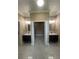Bathroom features dual sinks and mirrors, complemented by modern tile floors at 2420 Graham Dr, Orlando, FL 32807