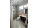 Modern bathroom features a tiled shower, updated vanity, a toilet, and neutral color walls at 2420 Graham Dr, Orlando, FL 32807