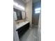 The main bathroom features a double vanity, sinks, mirrors, and ample lighting at 2420 Graham Dr, Orlando, FL 32807
