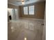 Spacious bedroom featuring a ceiling fan, large windows with blinds, and stylish marble floors at 2420 Graham Dr, Orlando, FL 32807
