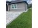 Exterior showing a new paver driveway and green lawn of this charming home at 2420 Graham Dr, Orlando, FL 32807