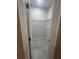 Well-lit walk-in closet with ample shelving and marble floors to maximize storage space at 2420 Graham Dr, Orlando, FL 32807
