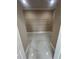 Walk-in closet space offers shelving and storage solutions, complemented by modern tile floors at 2420 Graham Dr, Orlando, FL 32807