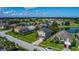 Aerial view capturing a community with a golf course and lake, convenient street access at 2530 The Oaks Blvd, Kissimmee, FL 34746