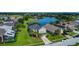 Aerial view showcasing a home near a golf course and a tranquil community lake at 2530 The Oaks Blvd, Kissimmee, FL 34746