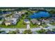 Overhead perspective of a home in a community with a golf course and a large pond at 2530 The Oaks Blvd, Kissimmee, FL 34746