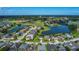 Scenic aerial view of a neighborhood near a golf course and community lake at 2530 The Oaks Blvd, Kissimmee, FL 34746