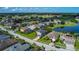Aerial view of a community next to a golf course, featuring scenic water views at 2530 The Oaks Blvd, Kissimmee, FL 34746