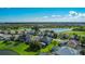 Aerial view showcasing a residential community near a lake and golf course, highlighting the neighborhood's layout and scenic views at 2530 The Oaks Blvd, Kissimmee, FL 34746