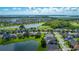 Expansive aerial of a residential area, emphasizing the community's proximity to both a lake and a green golf course at 2530 The Oaks Blvd, Kissimmee, FL 34746