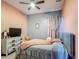 Bedroom with a full bed, a dresser with a TV, and grey, pink and white color scheme at 2530 The Oaks Blvd, Kissimmee, FL 34746
