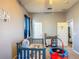 Bedroom with a crib, a changing table, a slide, and a trampoline. Great room or playroom at 2530 The Oaks Blvd, Kissimmee, FL 34746