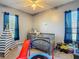 Bedroom with a crib, a teepee, a slide, and a trampoline. Great room or playroom at 2530 The Oaks Blvd, Kissimmee, FL 34746