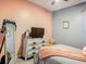 Bedroom featuring a bed, dresser with TV, and a soft, cozy blanket at 2530 The Oaks Blvd, Kissimmee, FL 34746