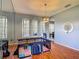 Large dining room with hardwood floors, ample natural light, and a designated play area at 2530 The Oaks Blvd, Kissimmee, FL 34746