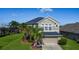 Beautiful two-story home with lush landscaping and a spacious driveway at 2530 The Oaks Blvd, Kissimmee, FL 34746